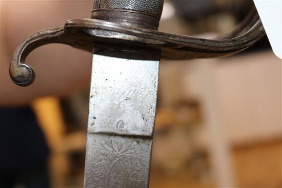 A Victorian sabre with etched blade and a mid 19th century sabre, both with scabbards